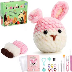 May include: Crochet kit to make a pink and white bunny. The kit includes yarn, a crochet hook, stuffing, and instructions. The box says "Crochet Kit" and includes a list of what is included.
