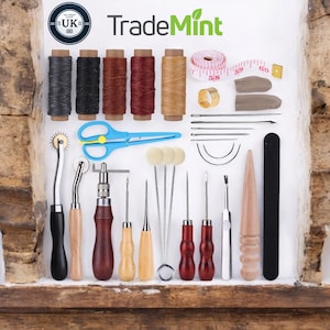 May include: A leathercraft kit featuring spools of thread, a measuring tape, needles, and blue scissors. The kit includes leather working tools with wooden and metal handles. The TradeMint logo is visible. The UK logo is also visible.