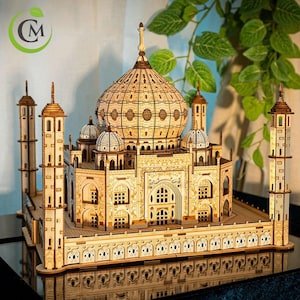 May include: A detailed wooden model of the Taj Mahal, a famous ivory-white marble mausoleum complex in Agra, India. The model features intricate details, including the central dome, minarets, and surrounding gardens.