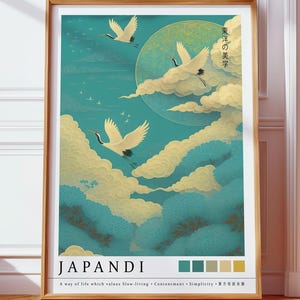 May include: A framed vertical poster featuring three white cranes flying through a teal sky with yellow clouds and a large moon. The text JAPANDI is printed at the bottom with a color palette and the phrase A way of life which values Slow-living.