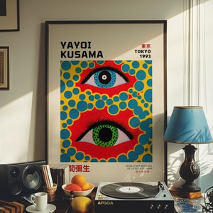 May include: A vintage poster featuring a colorful abstract design with two large eyes. The poster is titled "Yayoi Kusama" and includes the text "Tokyo 1993" and "間彌生".