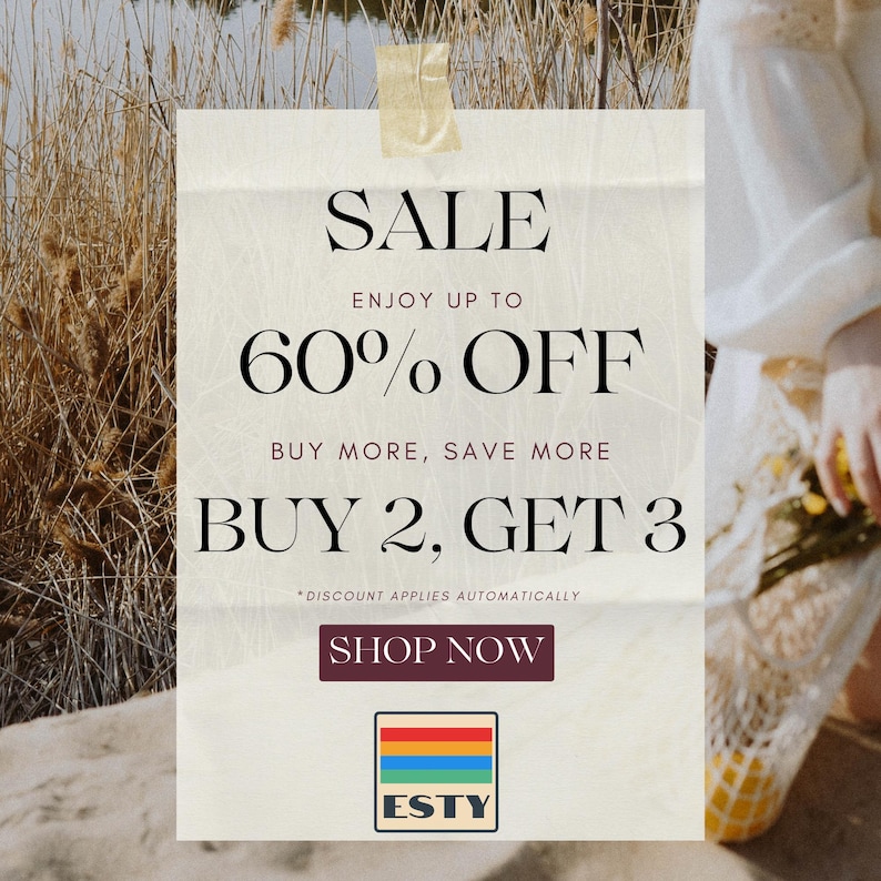a woman holding a bouquet of flowers next to a sale sign