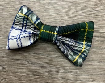 May include: A green, white, and yellow plaid bow tie with a white and blue plaid bow tie on the other side.