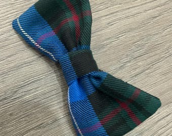 May include: A blue, green, red, and white plaid bow tie.