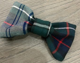 May include: A green, blue, white, and red plaid bow tie. The bow tie is tied in a classic bow shape.