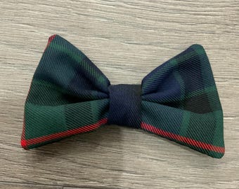 May include: A green, blue, and red plaid bow tie. The bow tie is tied and ready to wear.