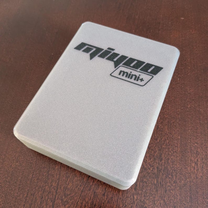 May include: A silver box with the text "mijoo mini+" printed on the top.
