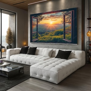 Puede incluir: Un gran lienzo que representa una ventana abierta con una puesta de sol. La obra de arte está colgada sobre un sofá seccional blanco con cojines negros y blancos. La habitación tiene un diseño moderno con colores neutros.
