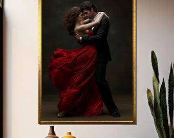 May include: A framed photograph of a couple dancing. The woman is wearing a flowing red dress and the man is wearing a black suit. The background is a dark gray.