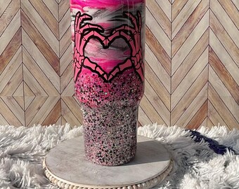 40oz Handle Stainless Steel Epoxy Resin Tumbler. Glittered bottom with swirl on top. Skeleton hand heart decal.  Amazing glow!!