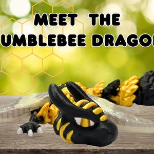 May include: A black and yellow articulated dragon figurine with translucent wings and white claws. The text "MEET THE BUMBLEBEE DRAGON" is displayed above the creature, which features a striped pattern on its head and body, resembling a bumblebee.
