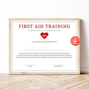 Può includere: Certificato incorniciato per la formazione di primo soccorso. Il certificato presenta un cuore rosso con un grafico del battito cardiaco e il testo "Certificato di completamento della formazione di primo soccorso".