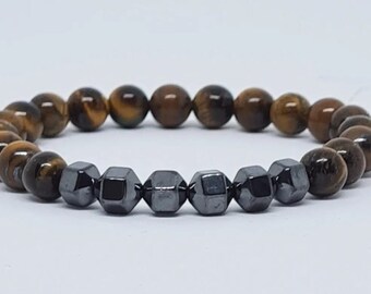May include: A brown and gold tiger's eye beaded bracelet with black hematite beads.