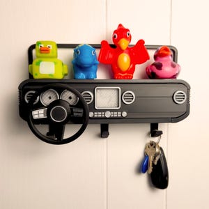 Show off your Jeep style with this fun and functional Duck Duck Jeep Display!

It holds 4 vending machine rubber ducks or 3 Hot Wheels cars, features a light-up front dash for extra flair, hidden storage for sunglasses or other small items, and 3 removable key hooks. Mount it on the wall or set it on a dresser or shelf—either way, it’s the perfect gift for Jeep lovers, Hot Wheels collectors, and ducking enthusiasts who want to organize in style!
