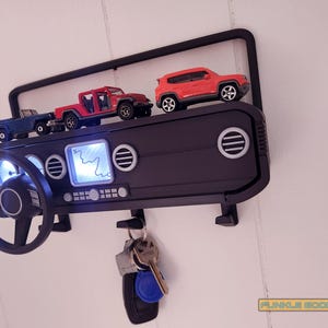 Show off your Jeep style with this fun and functional Duck Duck Jeep Display!

It holds 4 vending machine rubber ducks or 3 Hot Wheels cars, features a light-up front dash for extra flair, hidden storage for sunglasses or other small items, and 3 removable key hooks. Mount it on the wall or set it on a dresser or shelf—either way, it’s the perfect gift for Jeep lovers, Hot Wheels collectors, and ducking enthusiasts who want to organize in style!