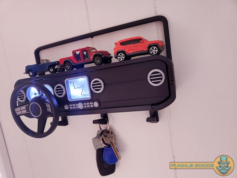 Show off your Jeep style with this fun and functional Duck Duck Jeep Display!

It holds 4 vending machine rubber ducks or 3 Hot Wheels cars, features a light-up front dash for extra flair, hidden storage for sunglasses or other small items, and 3 removable key hooks. Mount it on the wall or set it on a dresser or shelf—either way, it’s the perfect gift for Jeep lovers, Hot Wheels collectors, and ducking enthusiasts who want to organize in style!