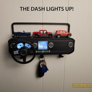 Show off your Jeep style with this fun and functional Duck Duck Jeep Display!

It holds 4 vending machine rubber ducks or 3 Hot Wheels cars, features a light-up front dash for extra flair, hidden storage for sunglasses or other small items, and 3 removable key hooks. Mount it on the wall or set it on a dresser or shelf—either way, it’s the perfect gift for Jeep lovers, Hot Wheels collectors, and ducking enthusiasts who want to organize in style!