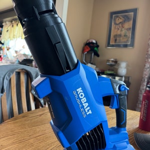 May include: A blue and black cordless leaf blower with a 40V MAX battery. The blower has a black nozzle and the text "Kobalt Brushless" printed on the side.