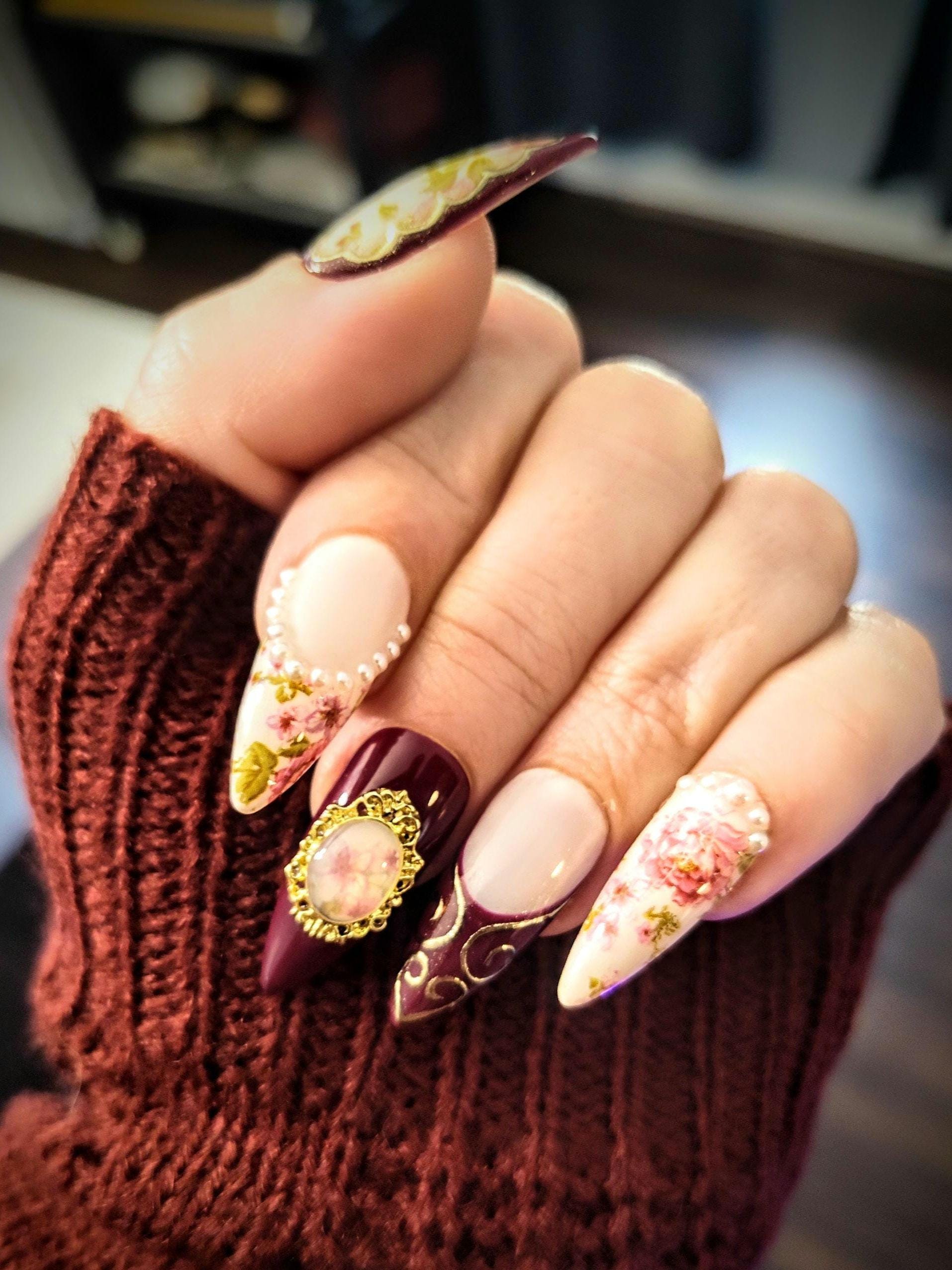 Glamorous Maroon Nails with Gold Veins