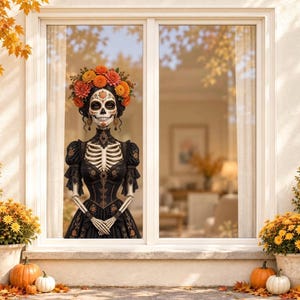 May include: A window decal featuring a skeletal figure with a sugar skull face, wearing a black dress with intricate embroidery and a large crown of orange and yellow chrysanthemums. The figure has a high collar and long sleeves, with hands clasped.