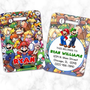May include: Two luggage tags featuring a colourful cartoon design of Mario and Luigi characters. The tag on the left has the name "RYAN" printed on it. The tag on the right has the text "THIS BELONGS TO: RYAN WILLIAMS 1234 N. Main Street Chicago, IL 12345 (123) 456-7890".