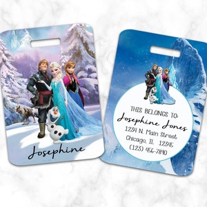 May include: A blue and white luggage tag with a picture of characters from the movie Frozen. The tag has a white circle with the text "THIS BELONGS TO Josephine Jones 1234 N. Main Street Chicago, IL 12345 (123) 456-7890".