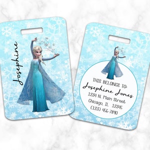 May include: A blue luggage tag with a snowflake pattern and a picture of Elsa from Frozen. The tag says "This belongs to: Josephine Jones" with an address and phone number.