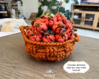 May include: A crocheted basket filled with crocheted red and brown balls. The basket is on a wooden surface. Includes detailed step-by-step video tutorial!