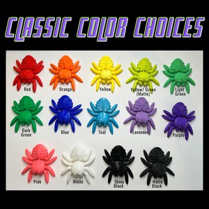May include: A collection of 14 3D printed spiders in various colors, including red, orange, yellow, green, blue, teal, lavender, purple, pink, white, and black. The spiders are arranged in two rows of seven, with the text "CLASSIC COLOR CHOICES" at the top.