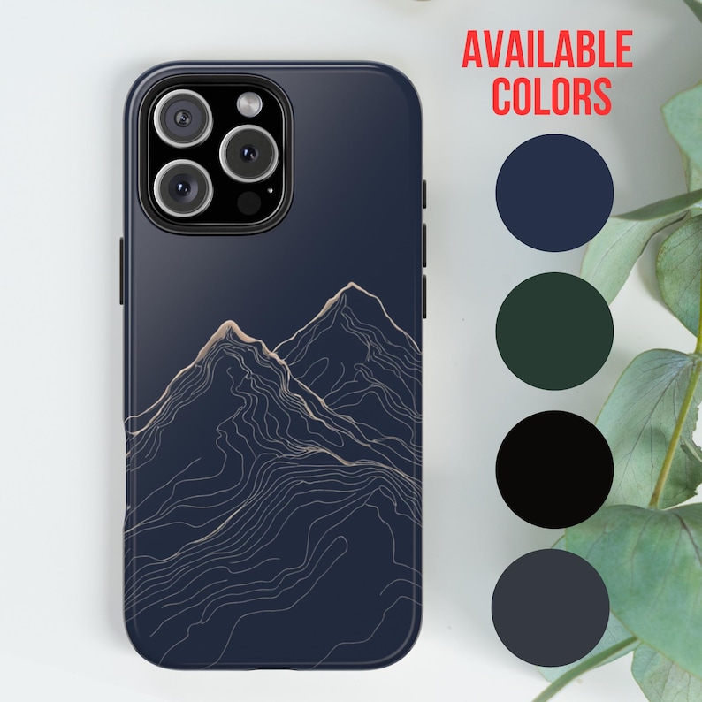 May include: A phone case with a dark blue background and a gold outline of mountains. The case is available in four colors: navy blue, dark green, black, and a lighter shade of blue. The text "AVAILABLE COLORS" is displayed above the color options.