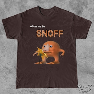 May include: A brown t-shirt with the text "allow me to SNOFF" printed in orange. An orange cartoon character with a large nose is holding a yellow flower.