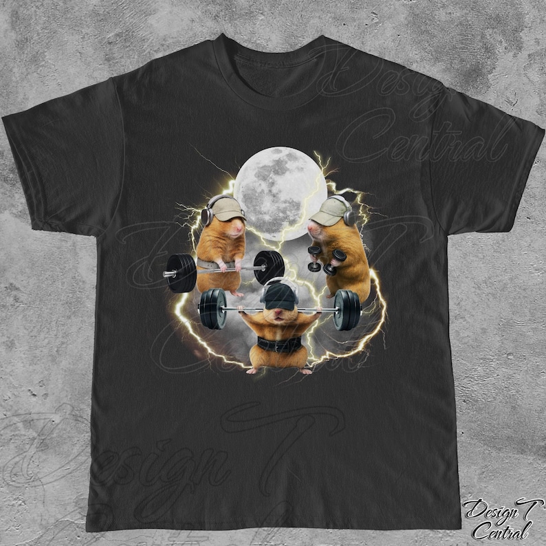 May include: Black t-shirt featuring a humorous graphic of three hamsters weightlifting. The hamsters are wearing hats and headphones, with a full moon and lightning in the background. The shirt has the text "Design Central" at the bottom.
