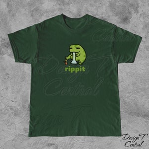 May include: A dark green t-shirt with a cartoon frog smoking a bong. The frog is green and has a relaxed expression. The text "rippit" is printed below the frog.