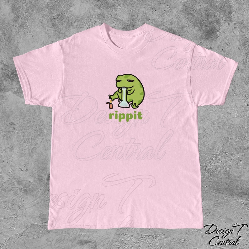May include: A pink t-shirt with a cartoon frog smoking a bong. The frog is green and has a relaxed expression. The text "rippit" is printed below the frog.