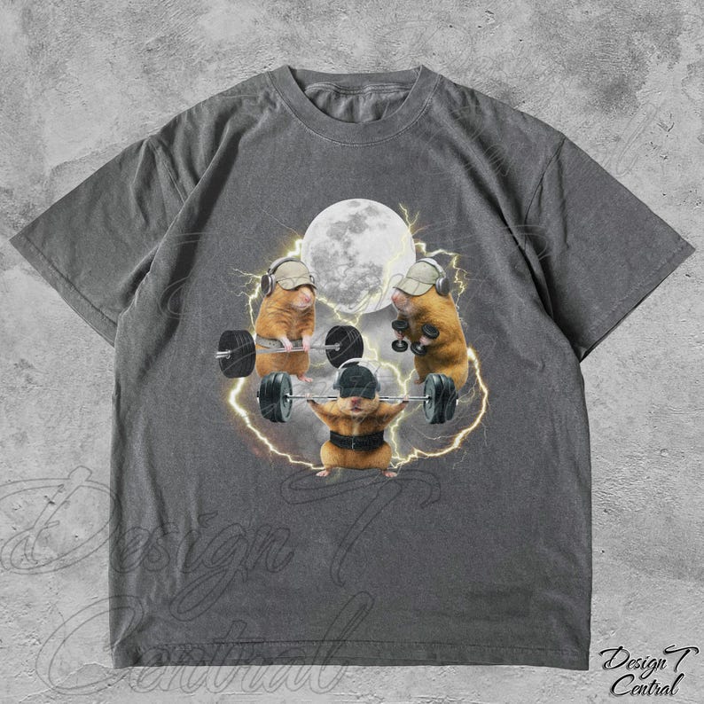 May include: Gray t-shirt featuring a graphic of three hamsters weightlifting under a full moon. The hamsters wear hats and headphones, with lightning bolts surrounding them. The shirt has a vintage, worn look.