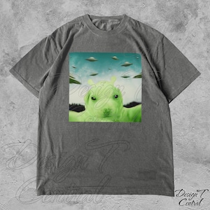 May include: A gray t-shirt with a graphic print of a green alien dog with a blue sky and flying saucers in the background.