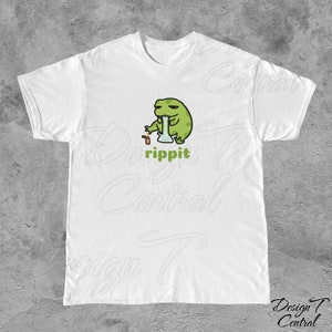 May include: White t-shirt with a green frog cartoon holding a glass bong and a lighter. The text "rippit" is printed below the frog.