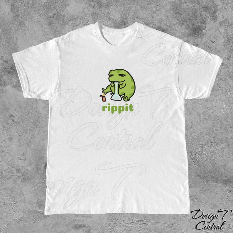 May include: White t-shirt with a green frog cartoon holding a glass bong and a lighter. The text "rippit" is printed below the frog.