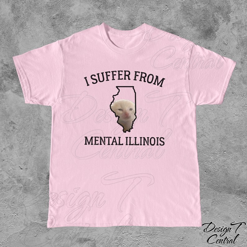 May include: Pink t-shirt with a black outline of the state of Illinois and a cat's face inside. The text "I suffer from mental Illinois" is printed on the shirt.