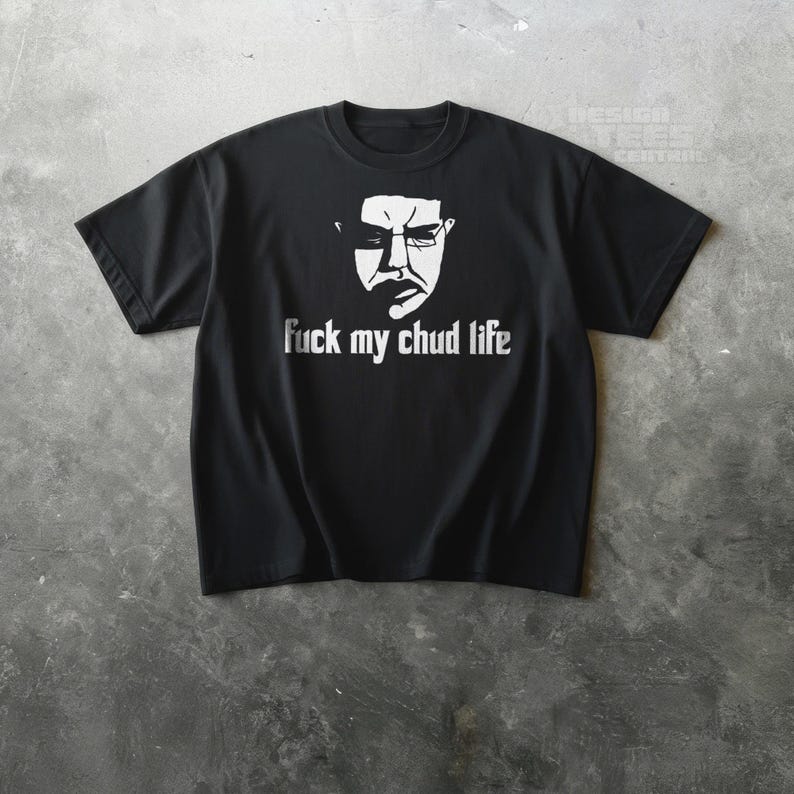 May include: Black t-shirt with a white graphic of a face and the text "fuck my chud life". The shirt is made of a soft material and has short sleeves and a crew neck.