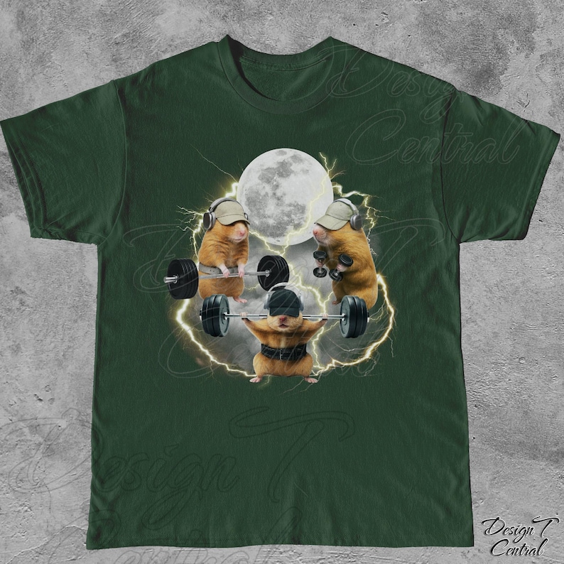May include: Dark green t-shirt featuring a humorous graphic of hamsters lifting weights. The design includes three hamsters with hats and headphones, lifting barbells under a full moon, with lightning bolts around them. The text "Design Central" is at the bottom.