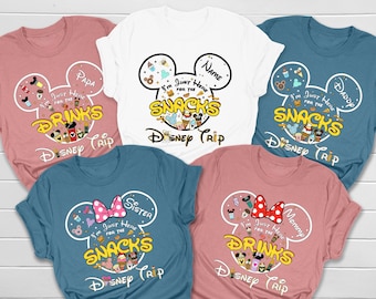 May include: Six t-shirts with a Mickey Mouse head design. Each shirt has a different text on it, including "I'm Just Here For The Snacks", "Drinks", "Sister", "Mommy", "Daddy", and "Papa".