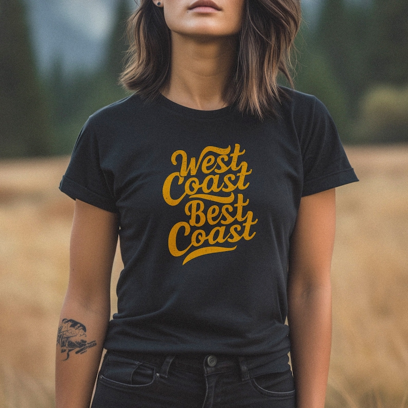 May include: A black t-shirt with a yellow graphic that says "West Coast Best Coast" in a retro font.