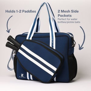 May include: A navy blue and white striped sports bag with a zippered pocket and two mesh side pockets. The bag has a padded compartment for holding 1-2 paddles. The bag is labeled "ELEVET".