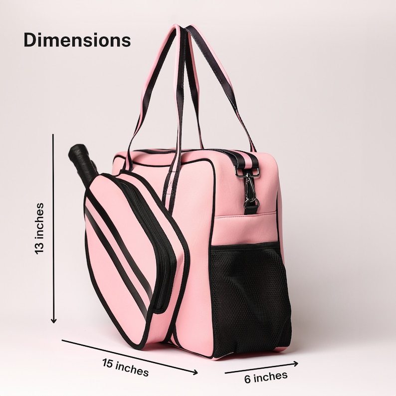 May include: Pink pickleball bag with a separate paddle compartment. The bag measures 15 inches wide, 13 inches tall, and 6 inches deep.