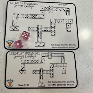 May include: Two white cards with black dominoes and the text "Let's Play Some Bones Savings Challenge" and "Save $147".  The cards have instructions to roll two dice, fill in the domino, and save the combined amount.