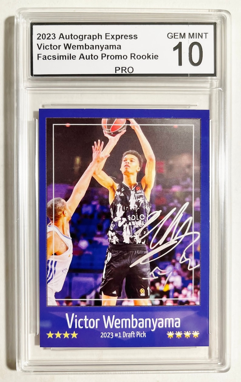 Puede incluir: Una tarjeta de baloncesto azul y blanca con Victor Wembanyama, el #1 Draft Pick de 2023. La tarjeta tiene una firma blanca y una calificaci&oacute;n GEM MINT 10.