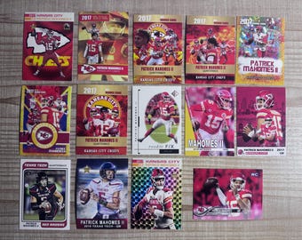 May include: A collection of 11 trading cards featuring Patrick Mahomes II, a professional American football quarterback. The cards are from different years and feature different designs, including rookie cards, game-used cards, and autographed cards. The cards are all in excellent condition.