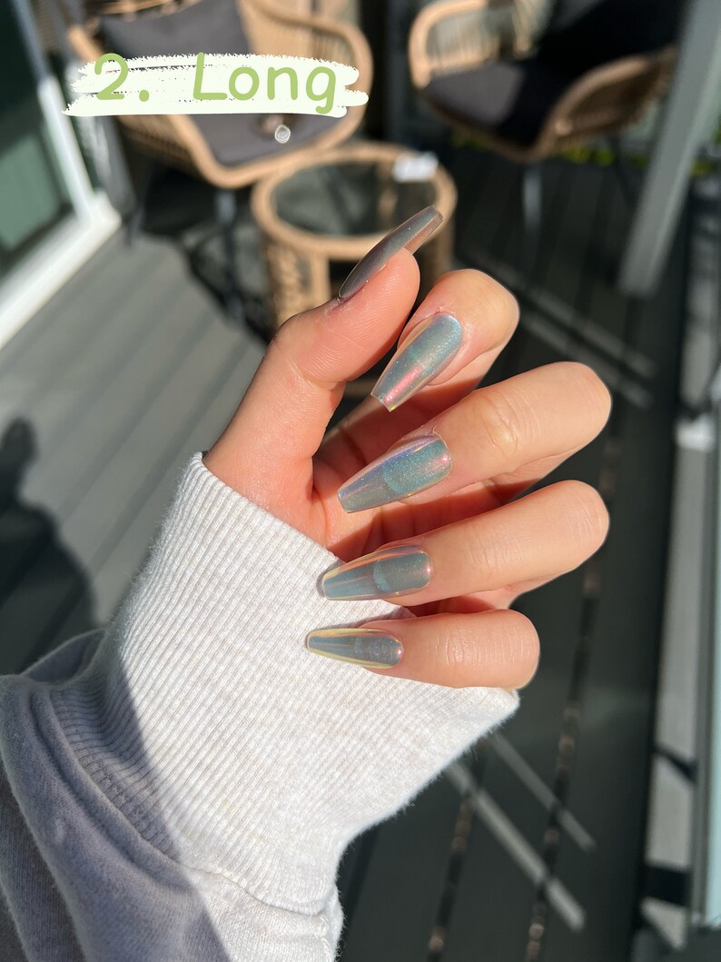 May include: Long, iridescent, light gray coffin-shaped press-on nails.