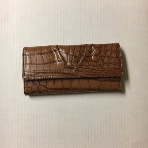May include: A brown leather wallet with a crocodile-embossed pattern.